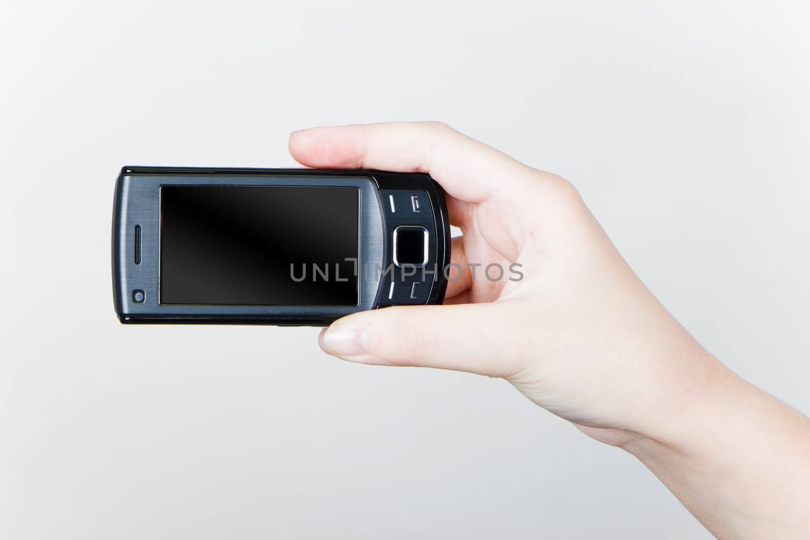 mobile phone in a female hand on a light background