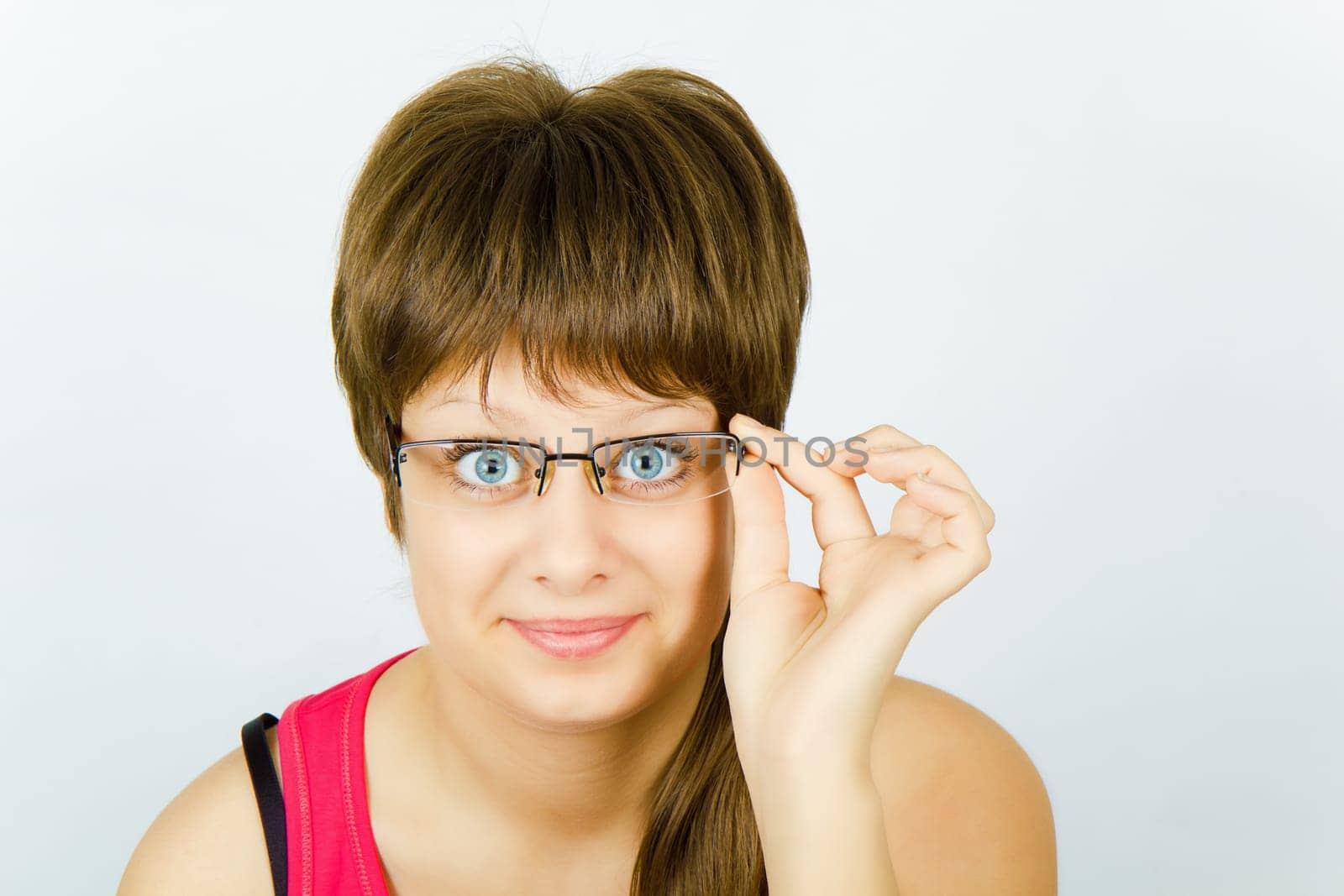 smiling blue-eyed surprised a beautiful young girl with glasses