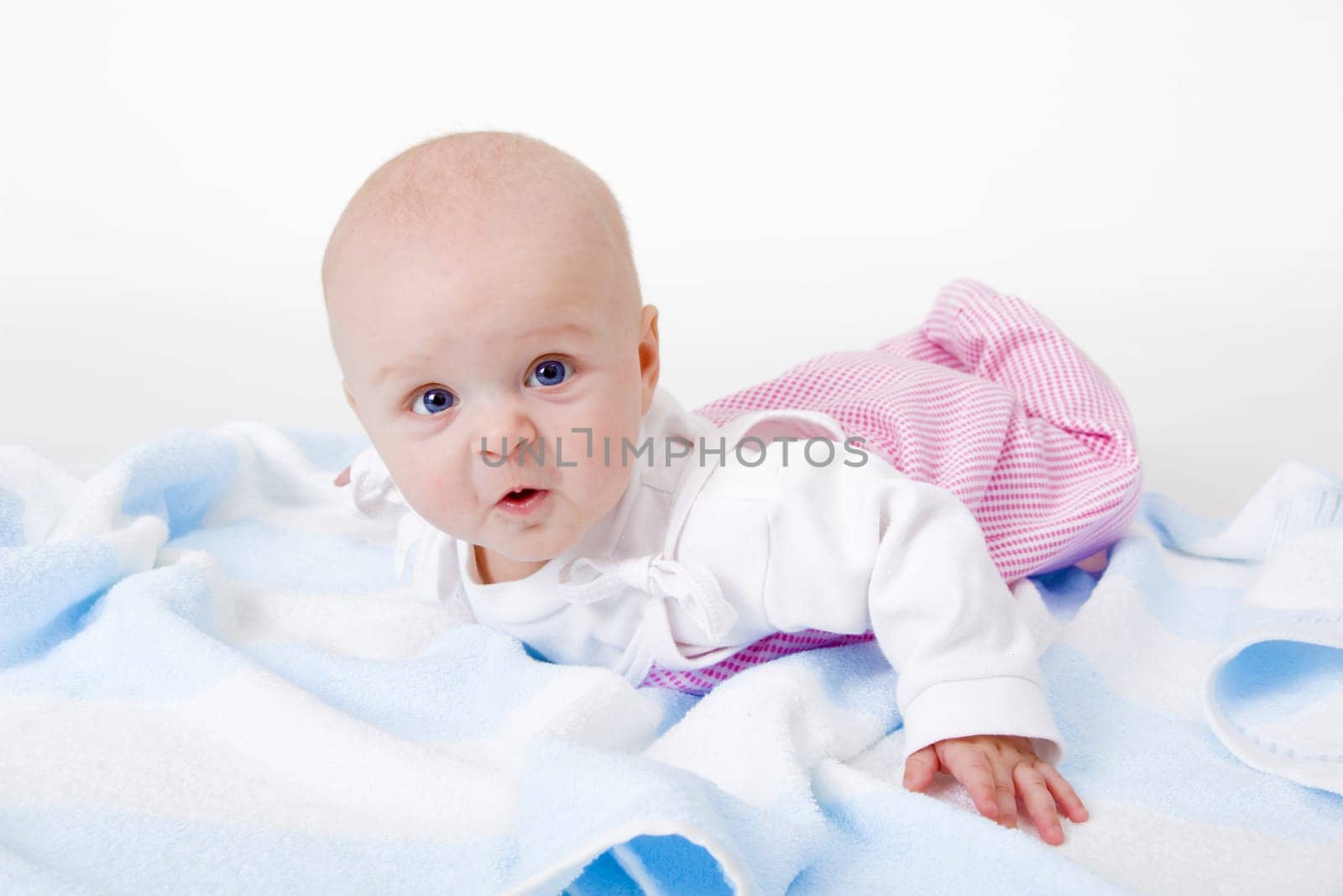 baby girl lying on a white background