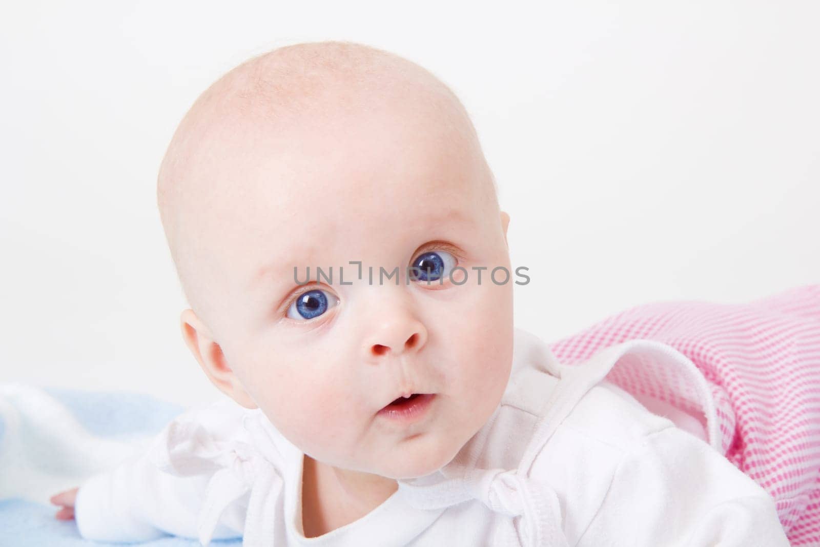 baby girl lying on a white background