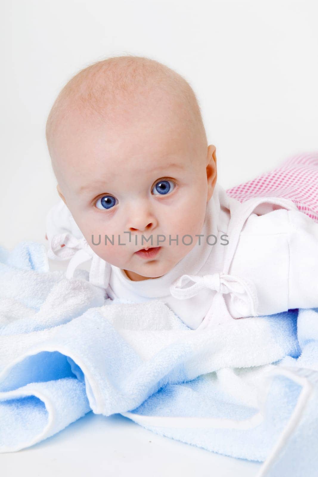 baby girl lying on a white background