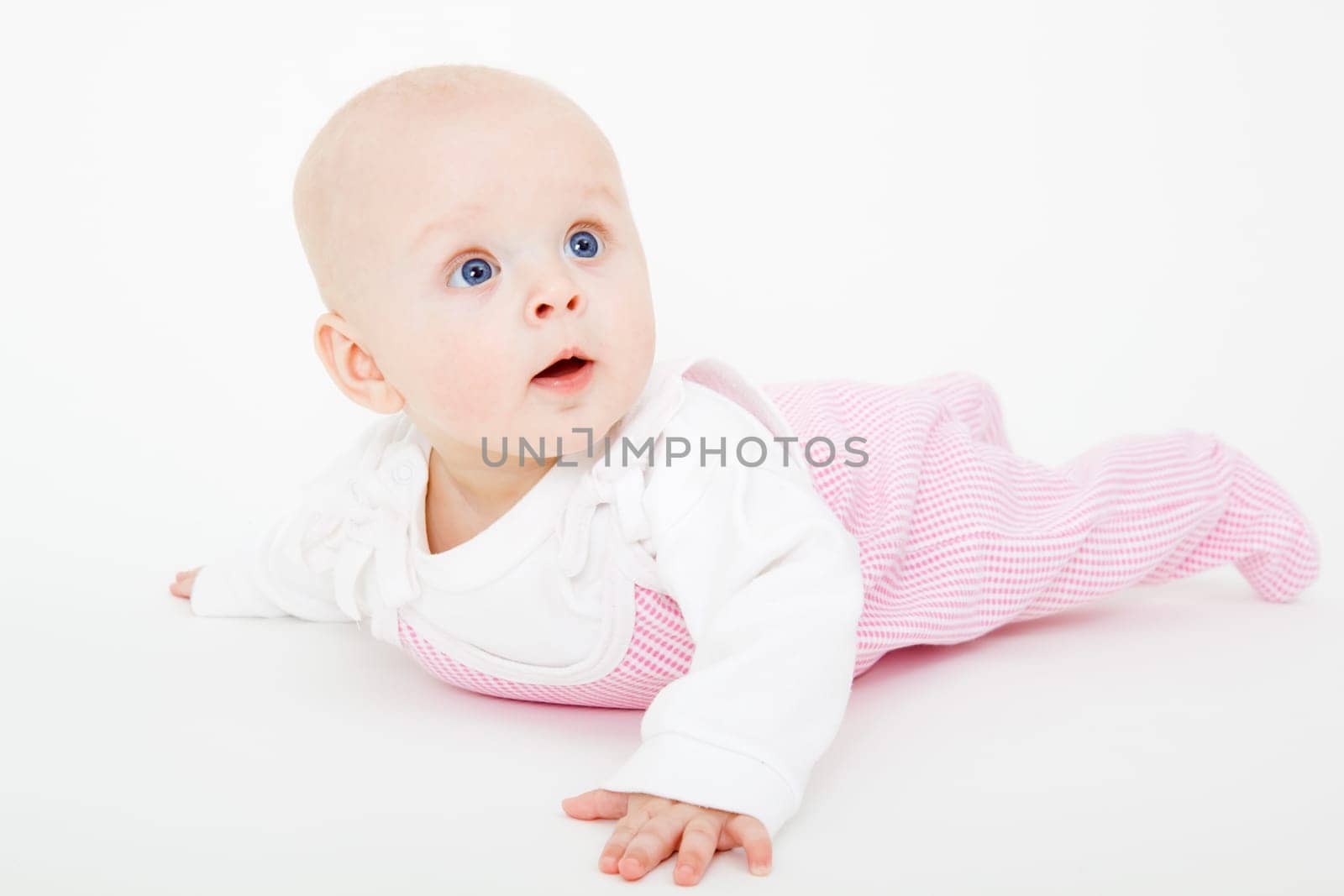 baby girl lying on a white background