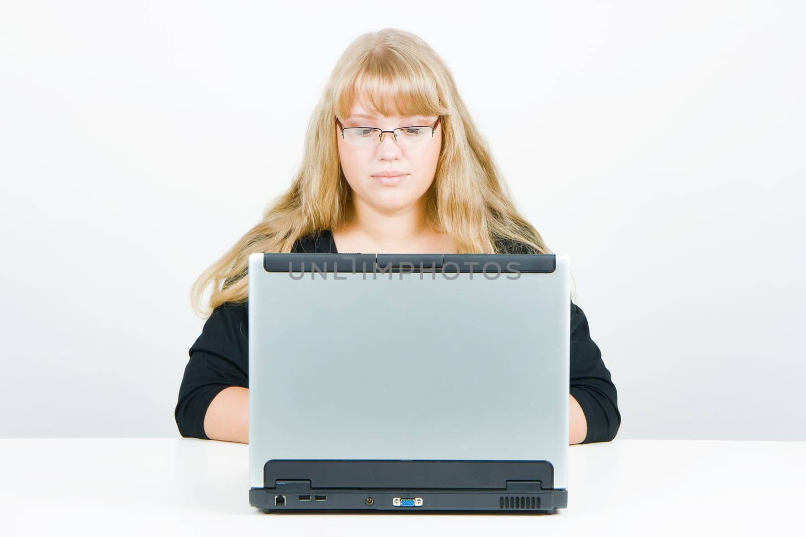 blonde with long beautiful hair with a laptop