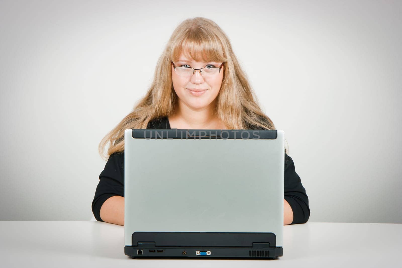 blonde with long beautiful hair with a laptop