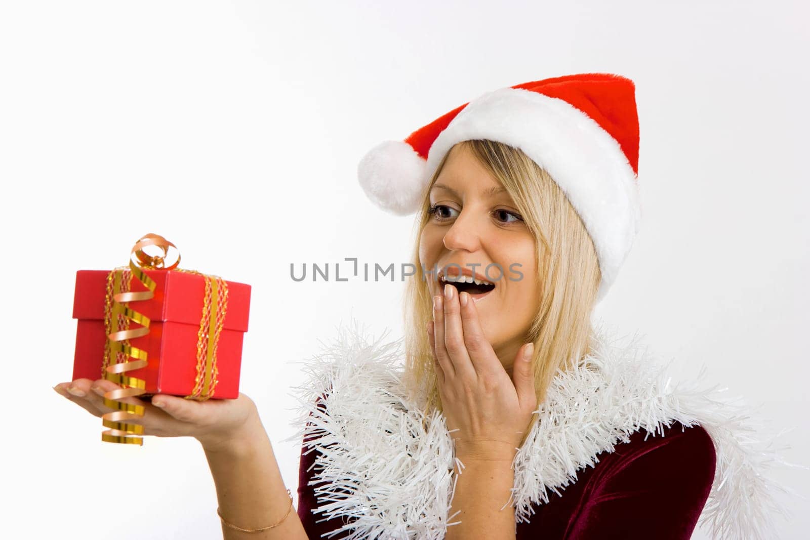 admiring a girl in a Christmas hat holding a New Year gift