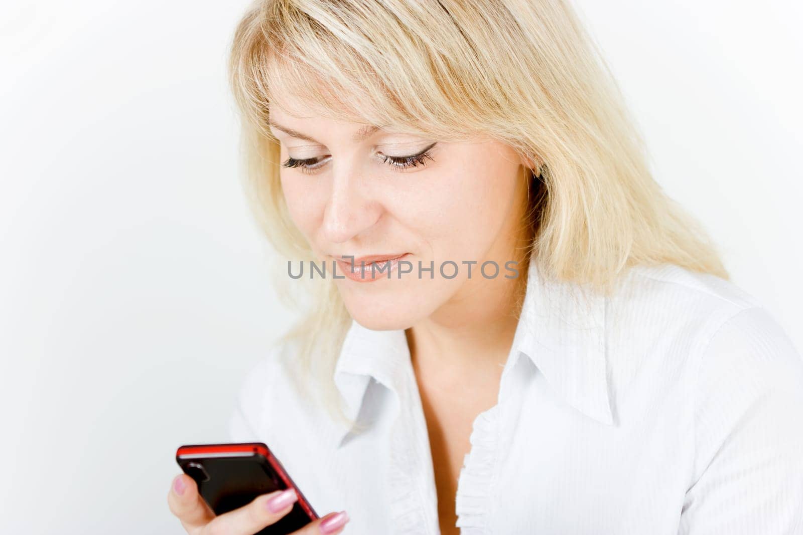 beautiful girl smiling blonde with the phone on a white background