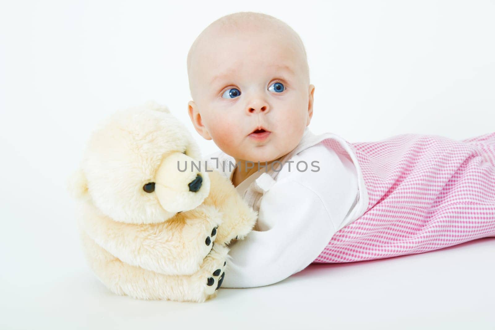 beautiful baby with a bear in the studio
