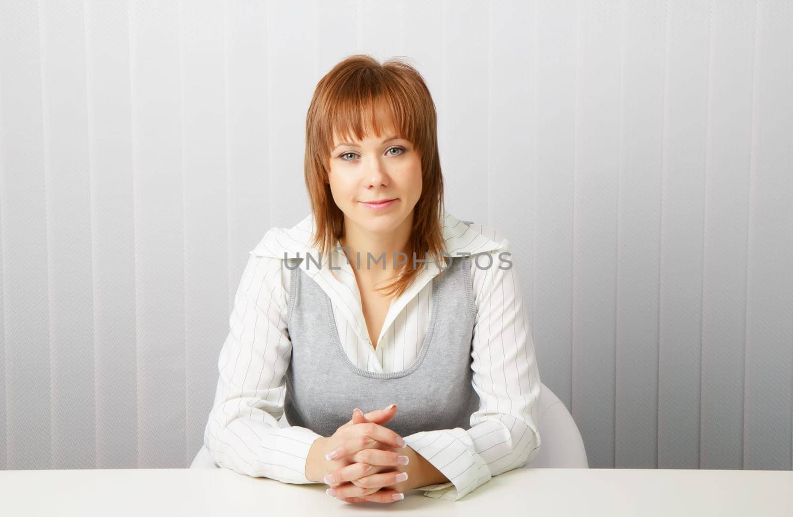 blue-eyed happy attractive young businesswoman in office