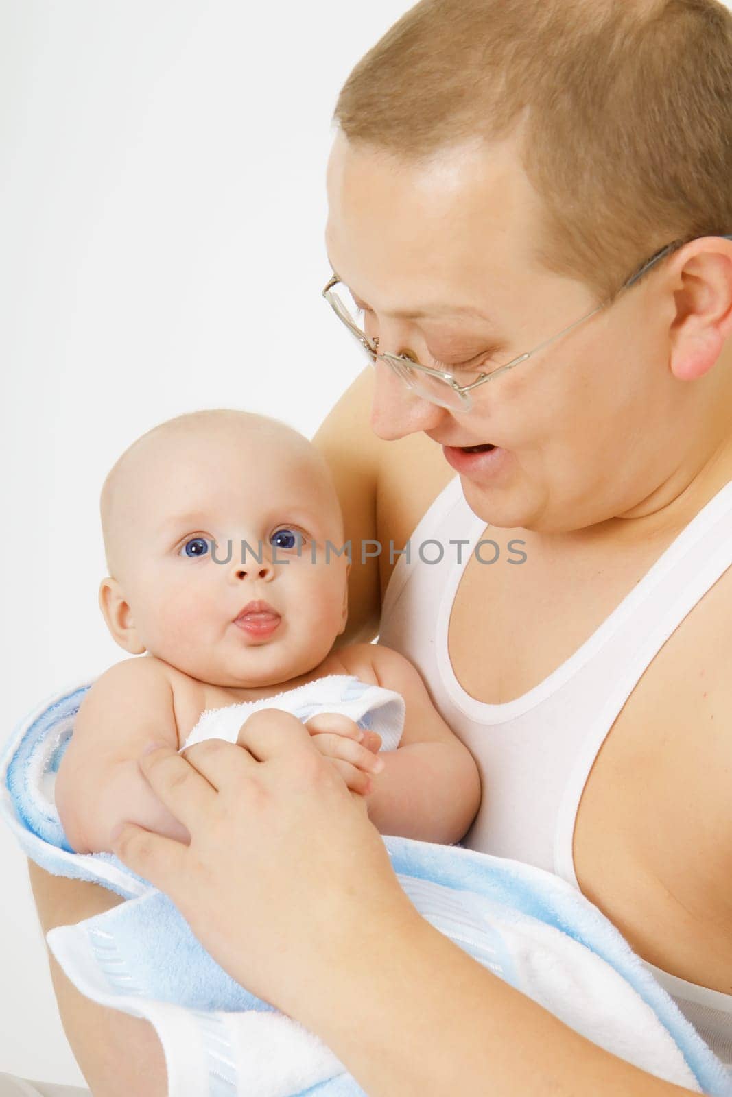 father is holding the baby. Studio photography
