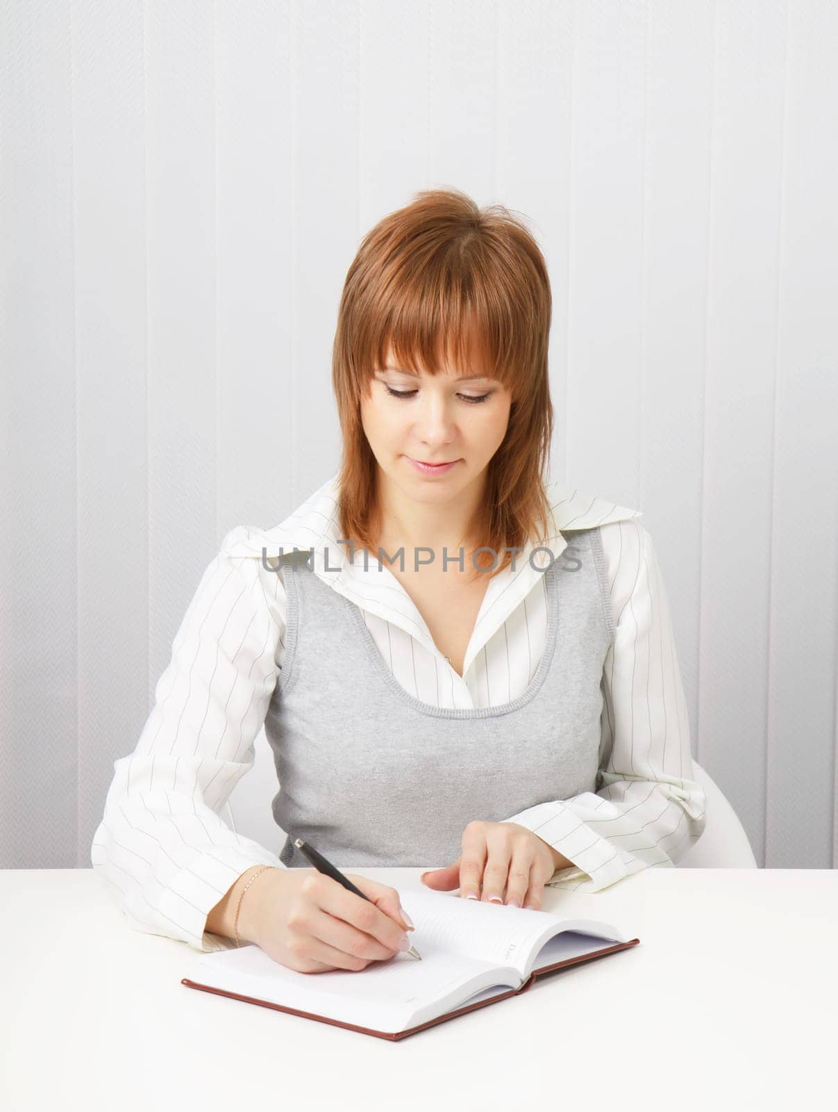 business attractive girl with a notebook and pen in the office.