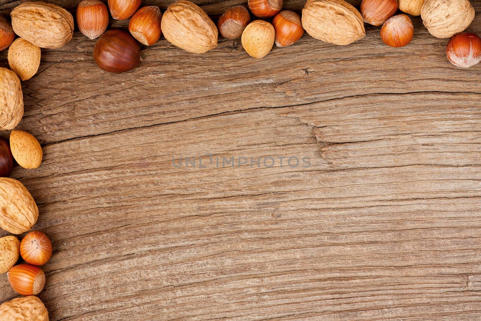 Background made of old wooden panel decorated with various nuts on two sides