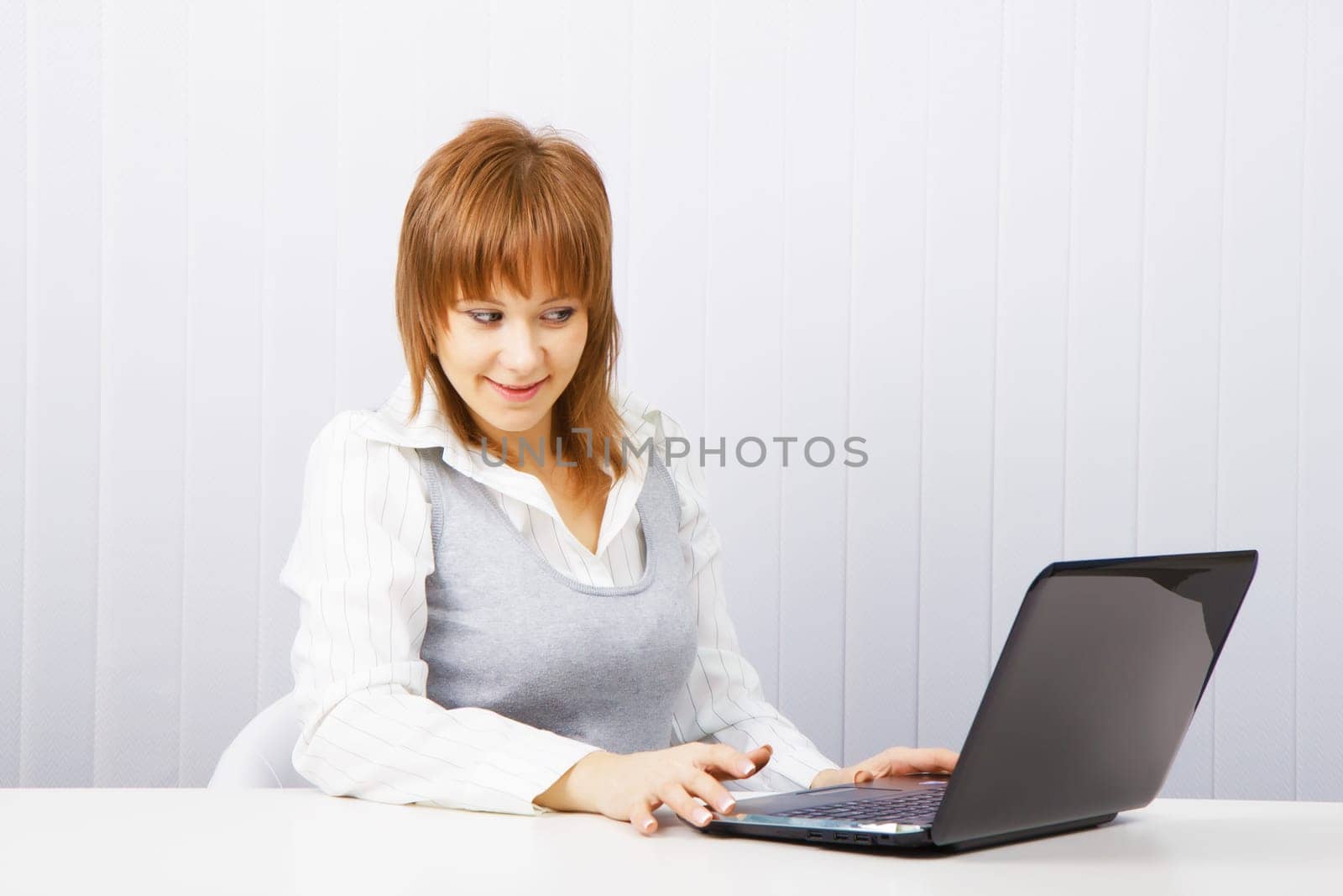 attractive young girl with surprise stares at the monitor laptop