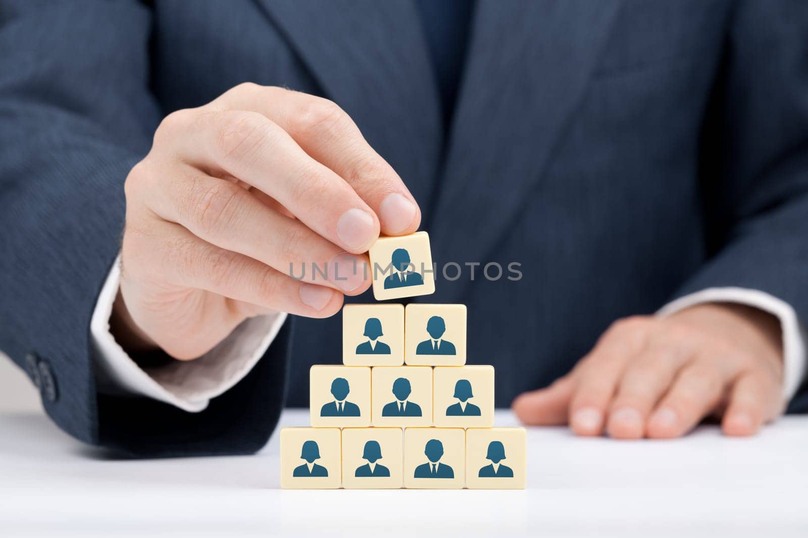 Human resources and corporate hierarchy concept - recruiter complete team by one leader person (CEO) represented by icon.