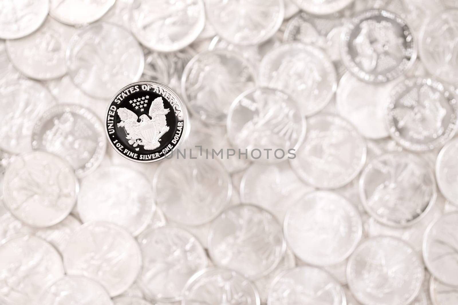 Silver eagle, one dollar coin on blurred money background