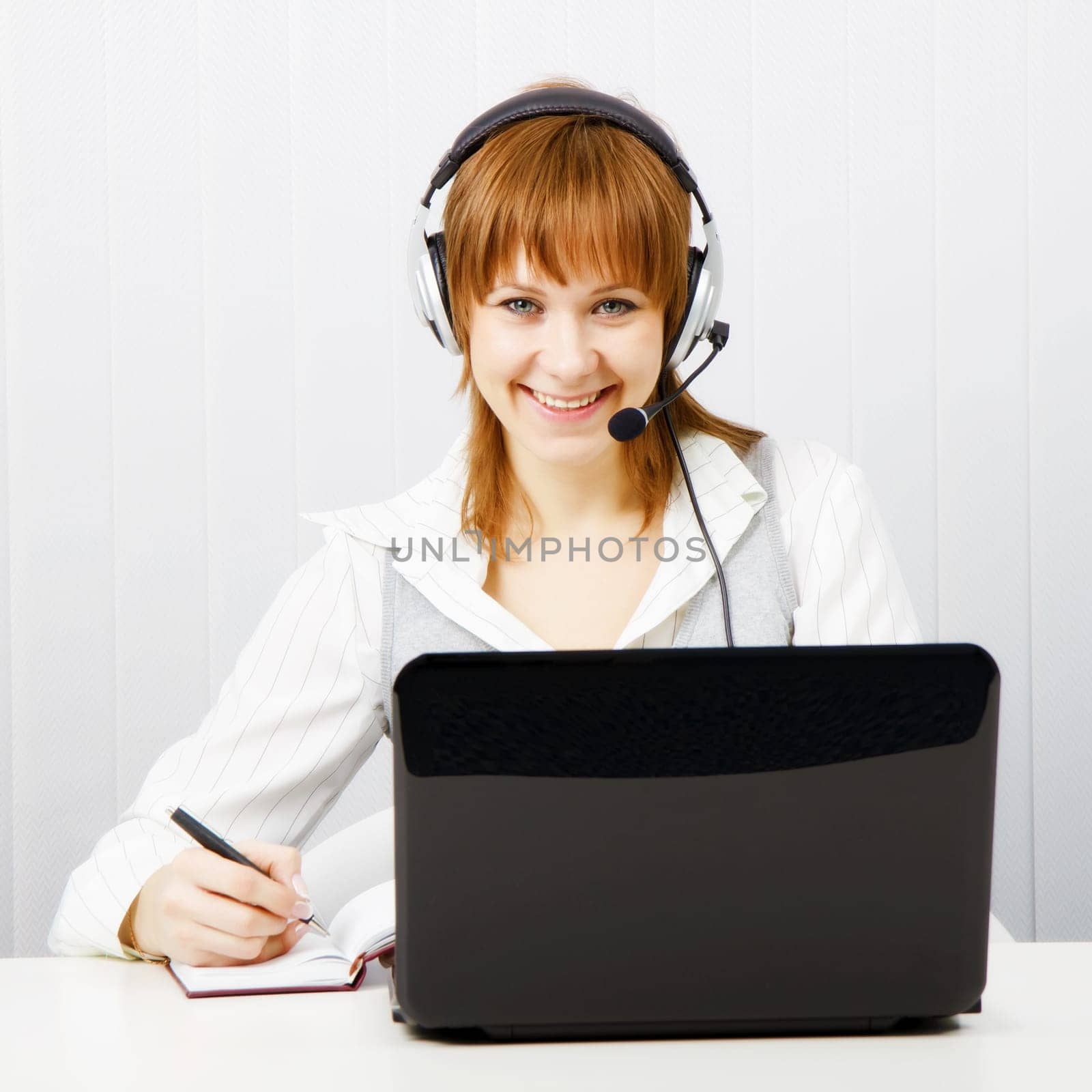 girl in headphones with a microphone. Worker Hotline