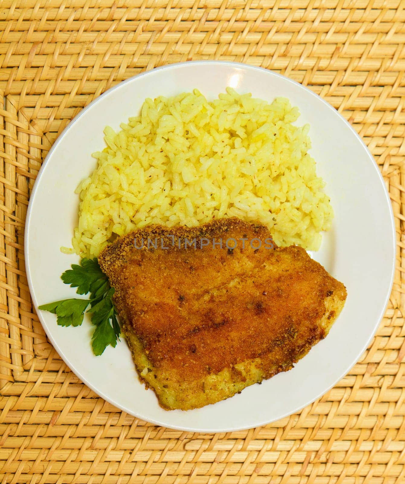 fried breaded tilapia served with rice and herbs