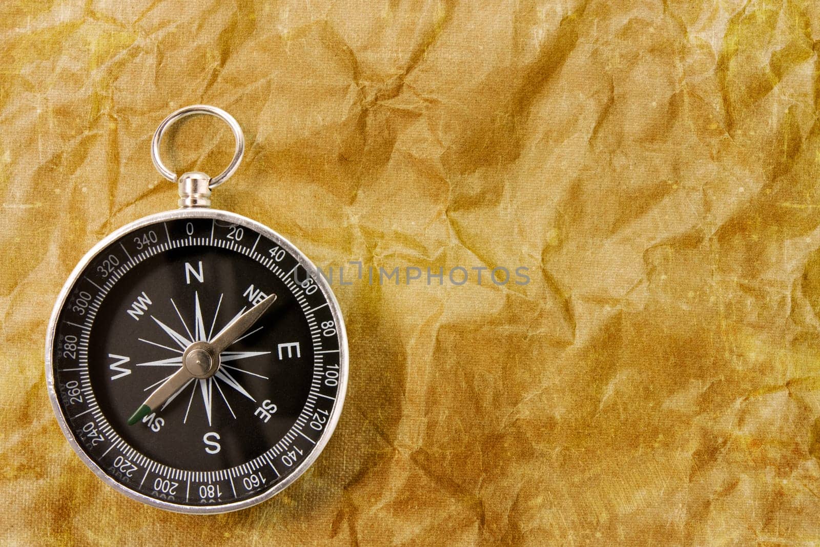 Black compass on the grunge paper background