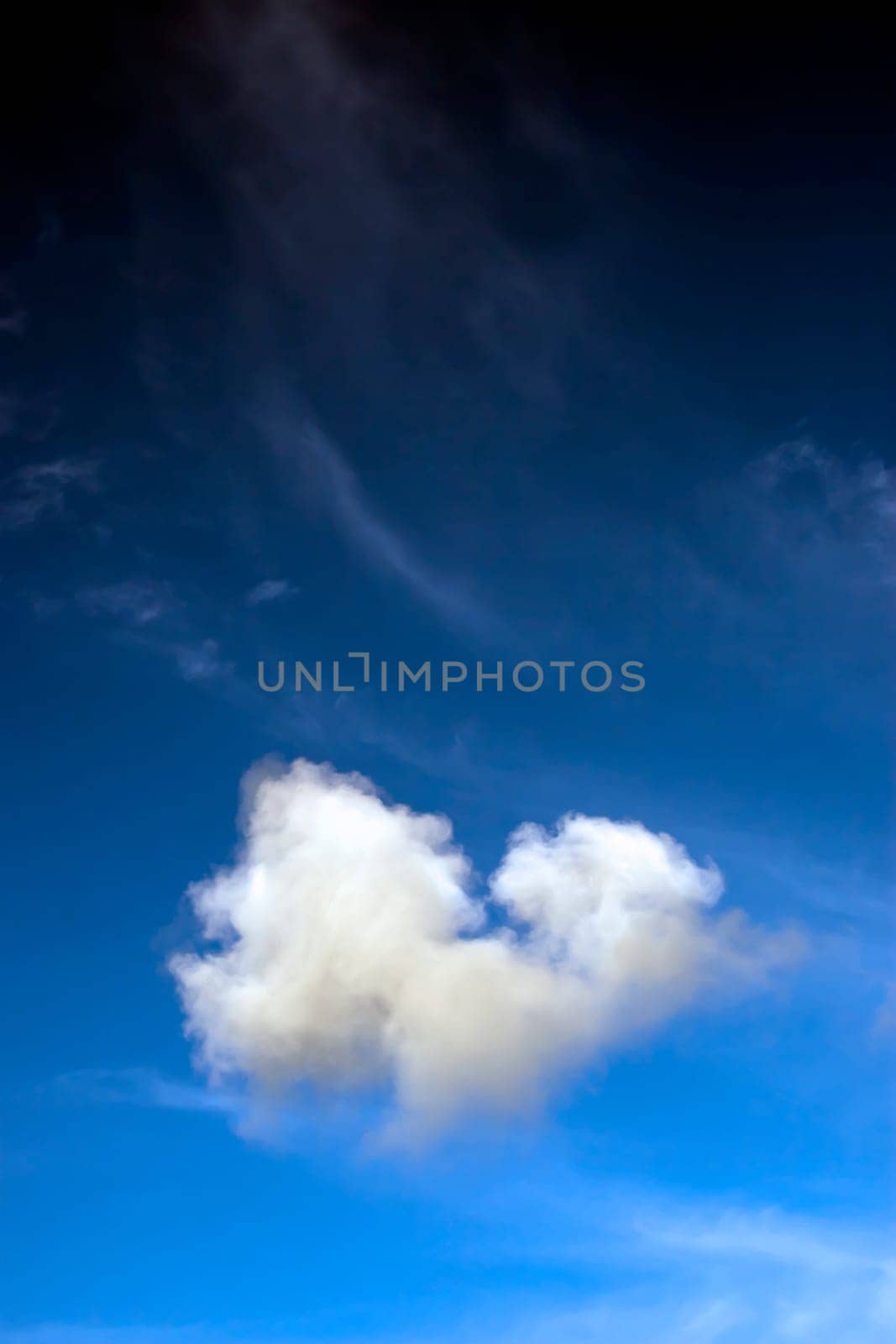 a natural heart shaped cloud in a beautiful blue sky with room for copy space