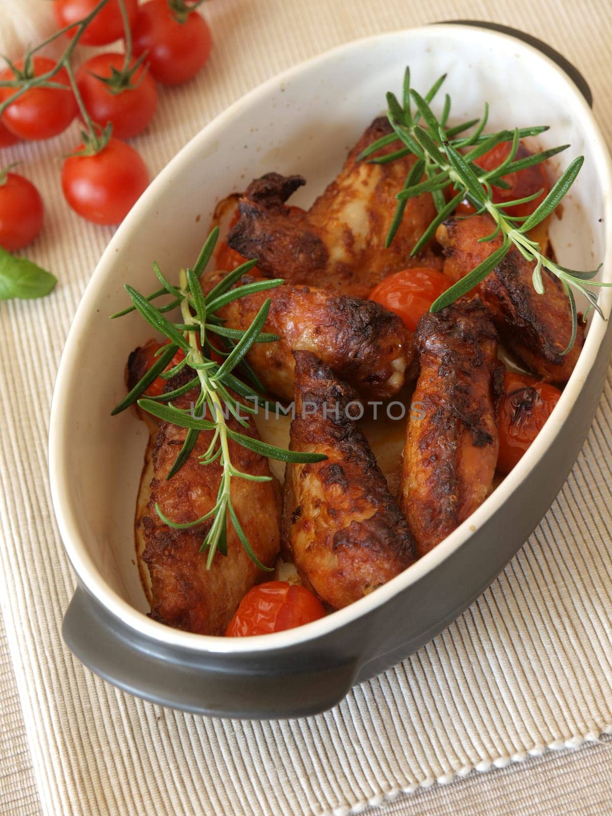 Spicy chicken wings in a creamic bowl with herbs