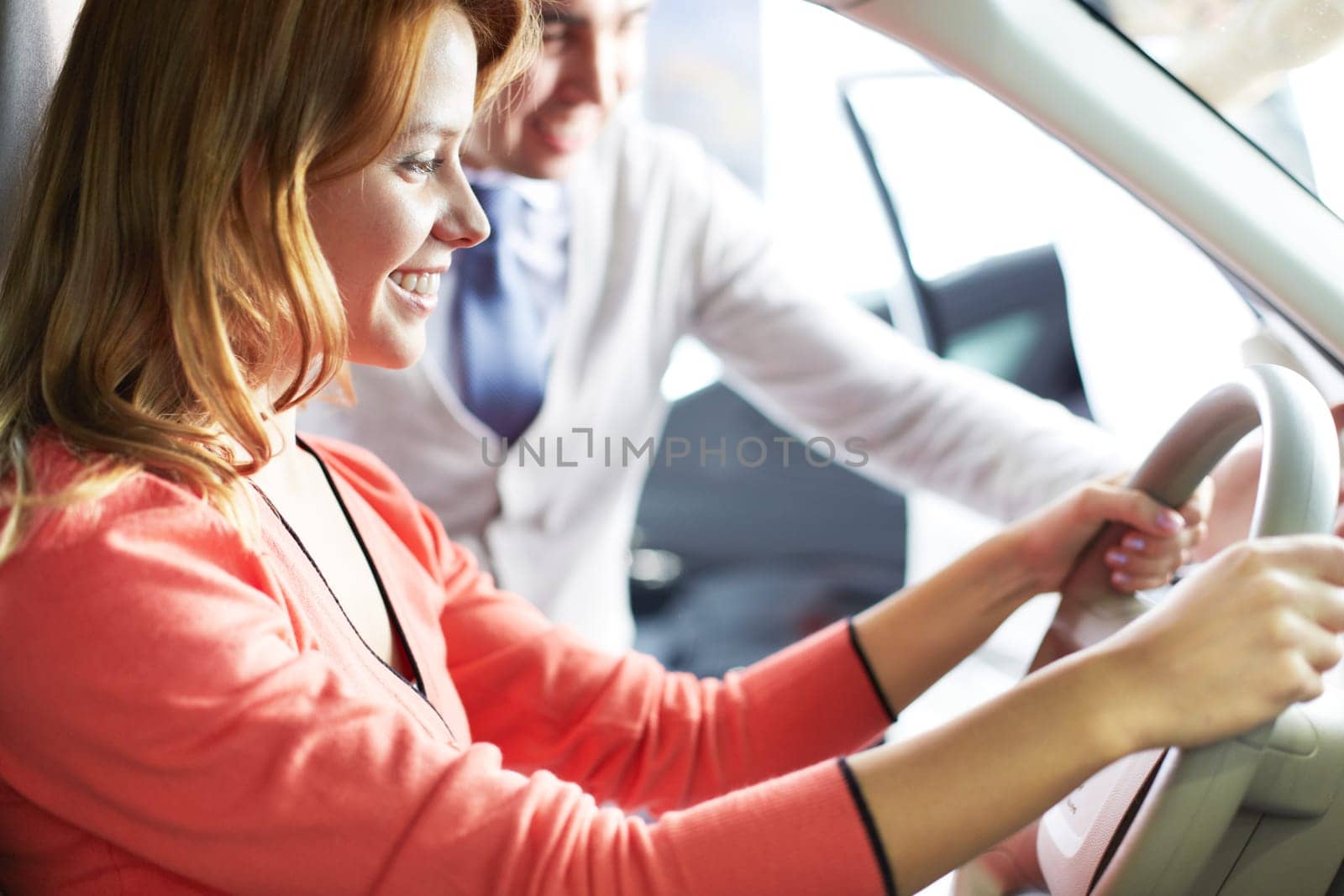 Photo of elegant woman sitting in car with salesman near by