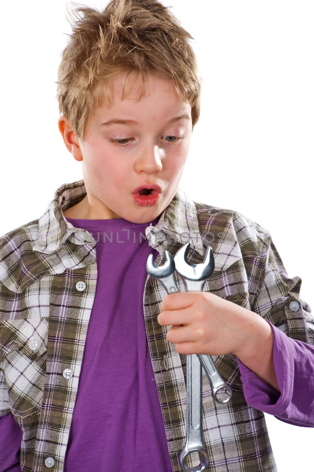 Boy with wrench is amazed