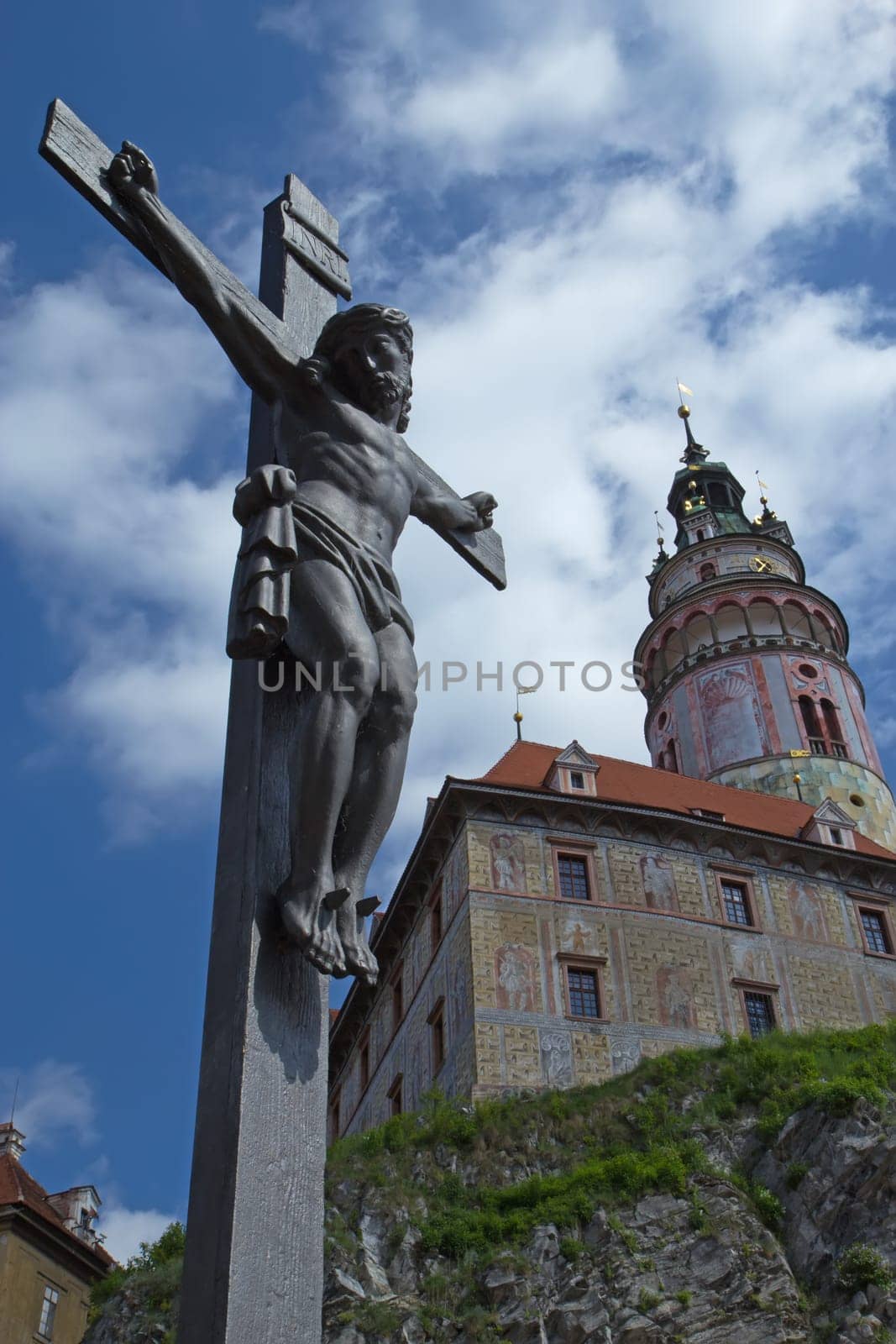 Jesus on the cross in Cesky Krumlov. Castle tower in the background. (Czech Republic)