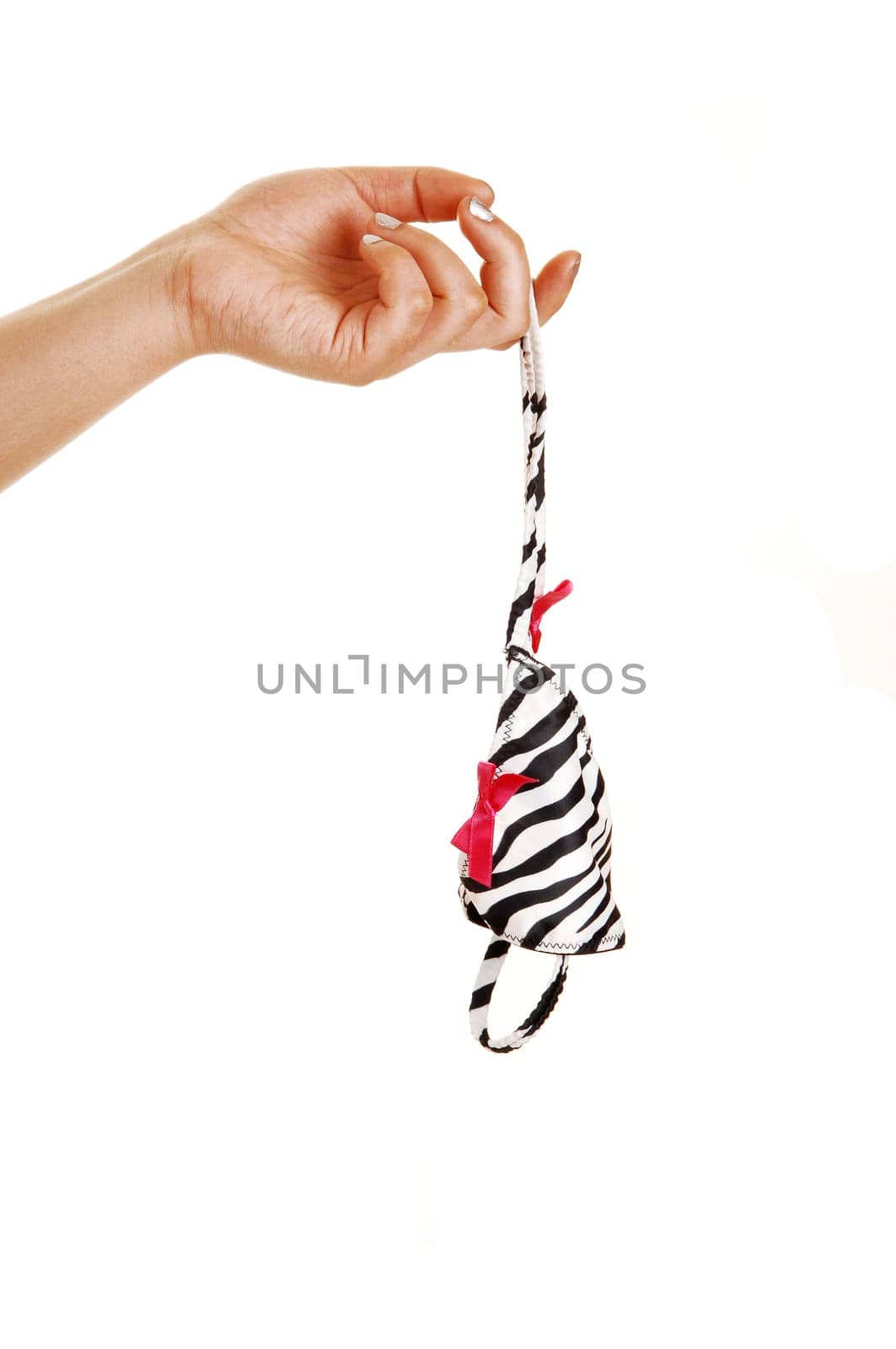 A single hand holding a white and black striped thong panty for  white background.