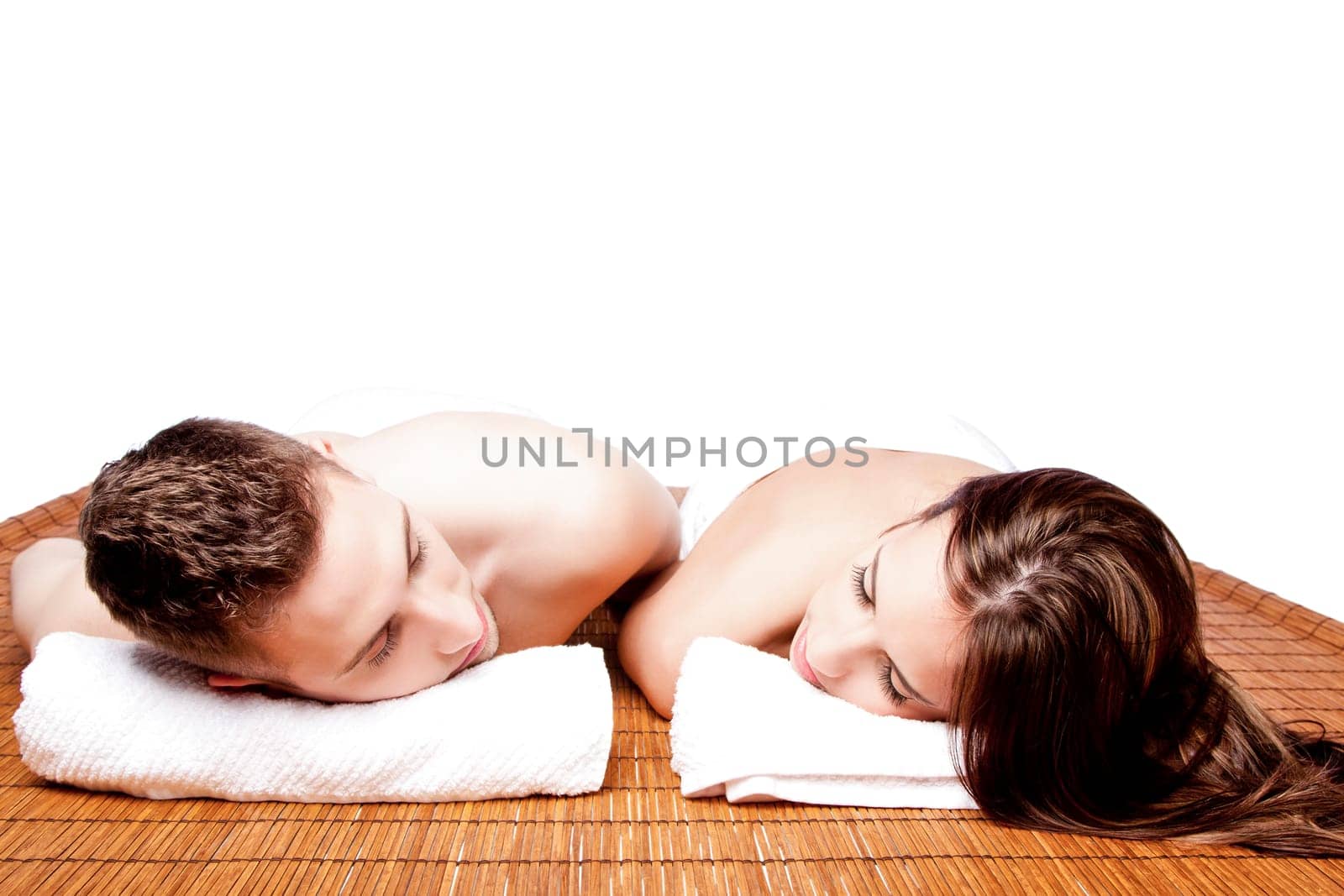 Couples holiday retreat at relaxing health spa for beauty treatment waiting for massage laying on bamboo.
