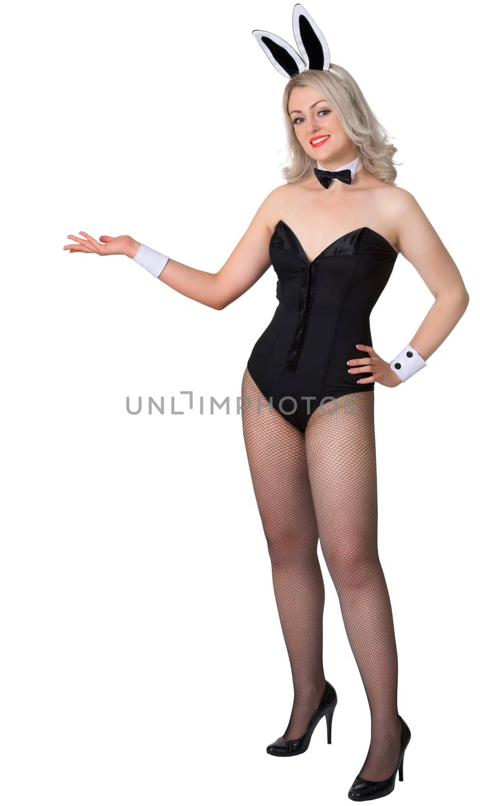 A girl dressed as a rabbit shows something isolated on white background