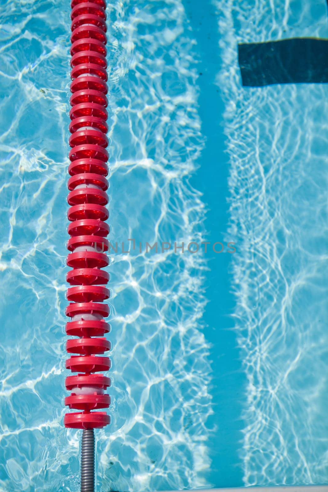 Closeup of red lane rope in swimming pool