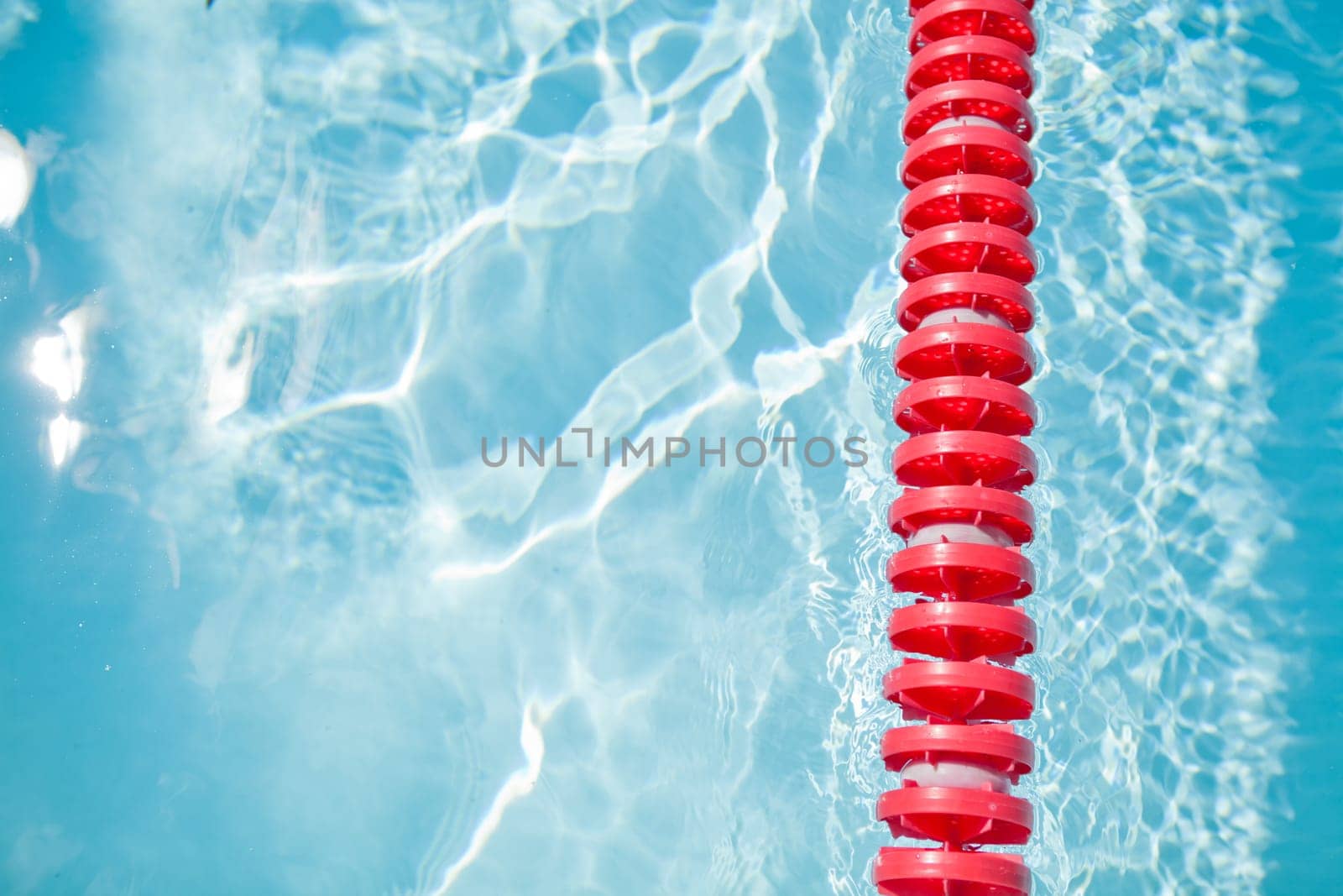 Closeup of red lane rope in swimming pool