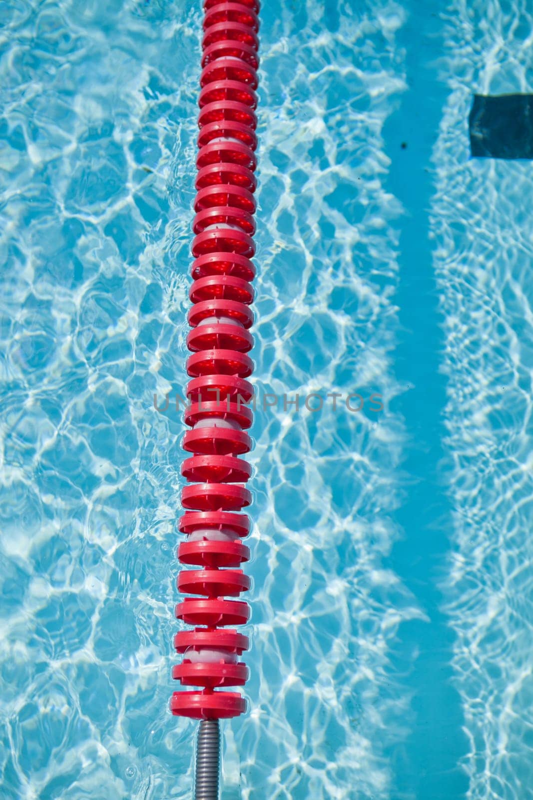 Closeup of red lane rope in swimming pool