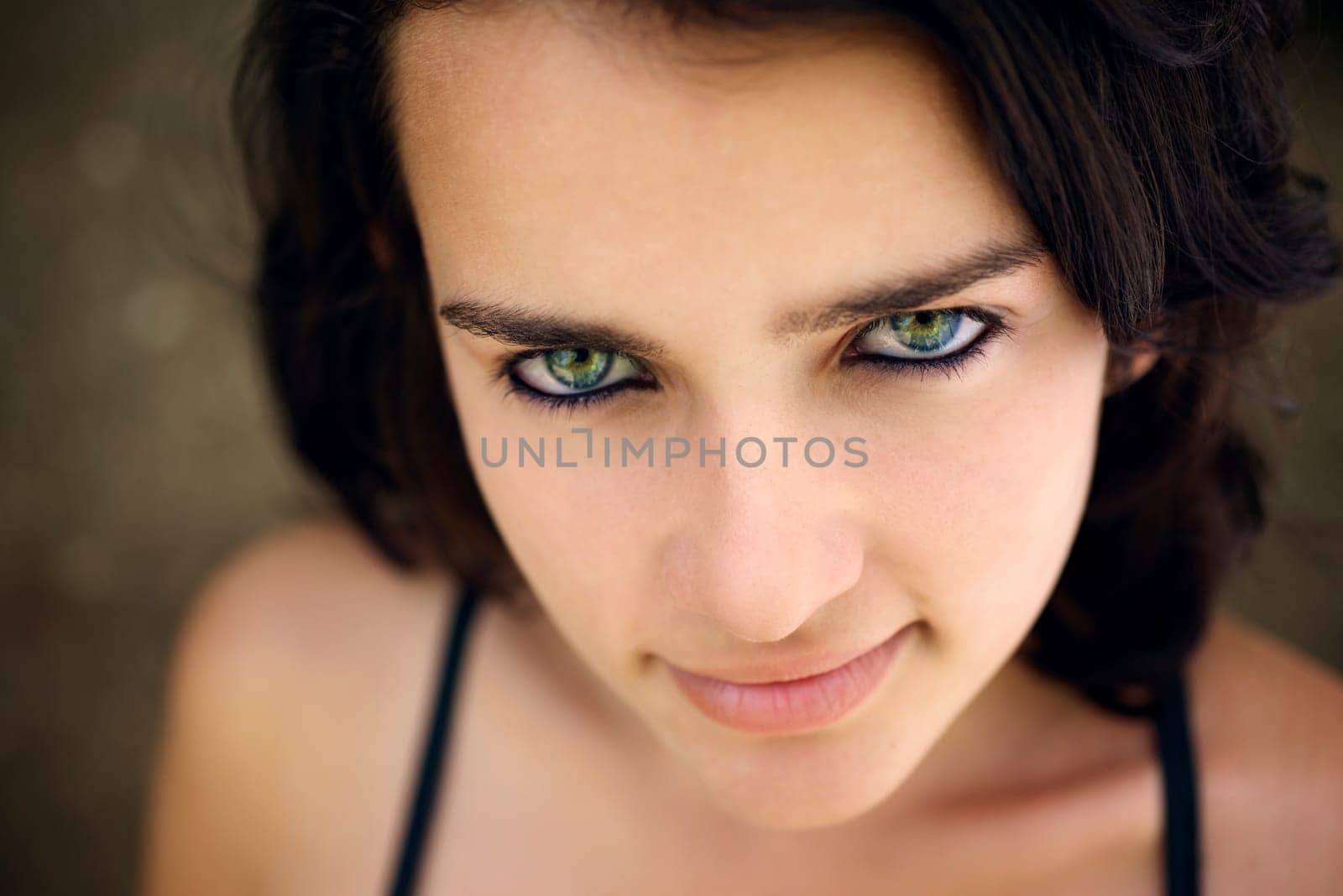 Pretty girl with green eyes, portrait of happy young hispanic woman looking at camera and smiling
