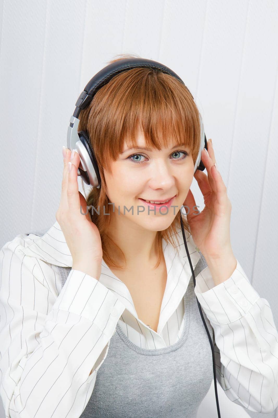 The girl in headphones listens to music with pleasure