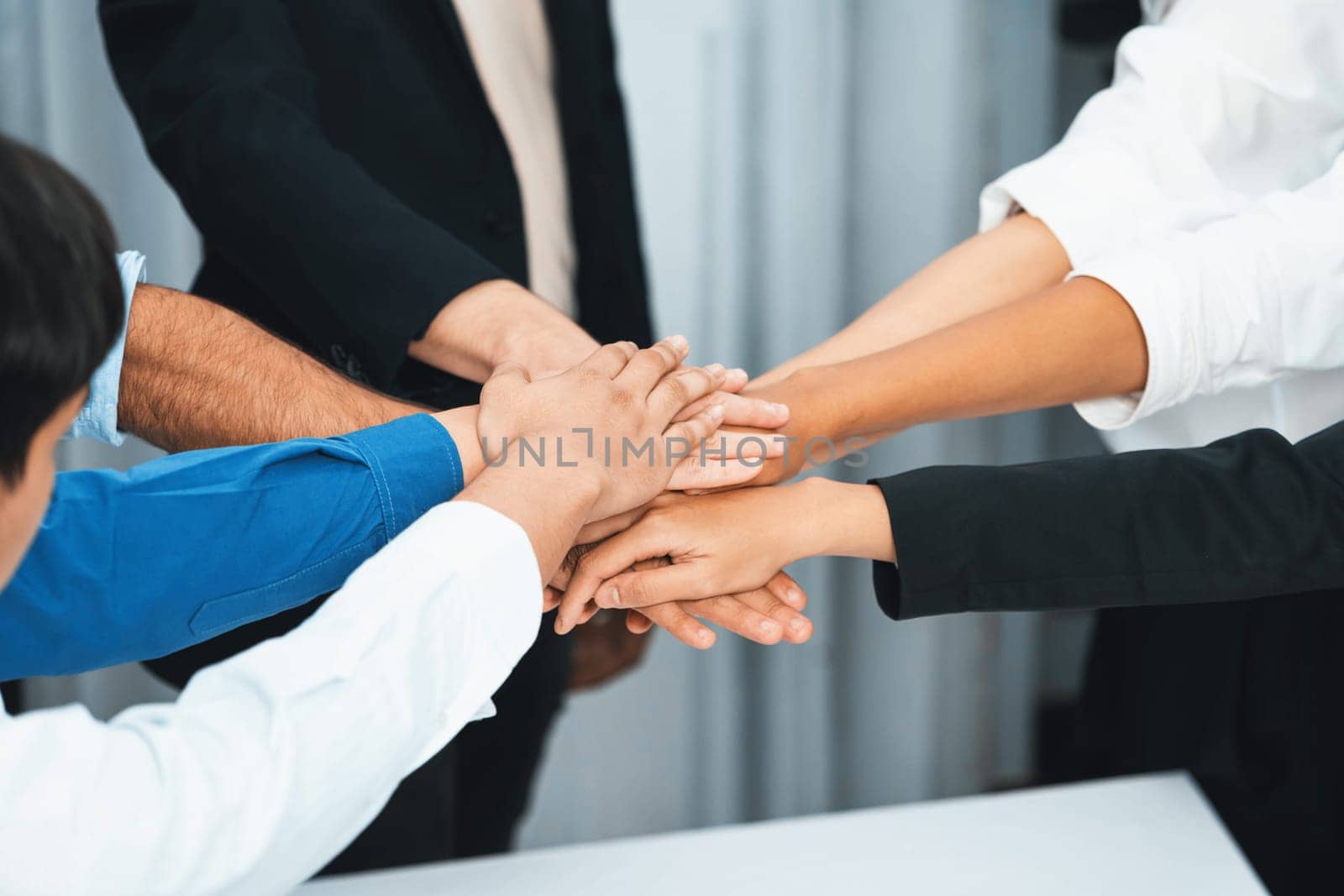 Group of diverse office worker join hand together in office. Prudent by biancoblue