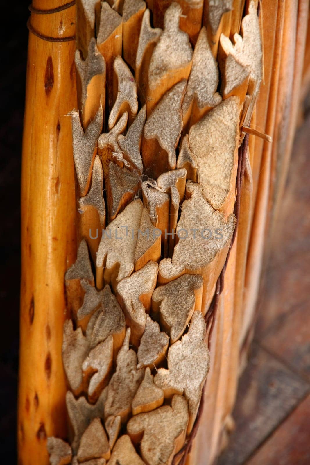 A closeup of the cut ends of a grass hut wall