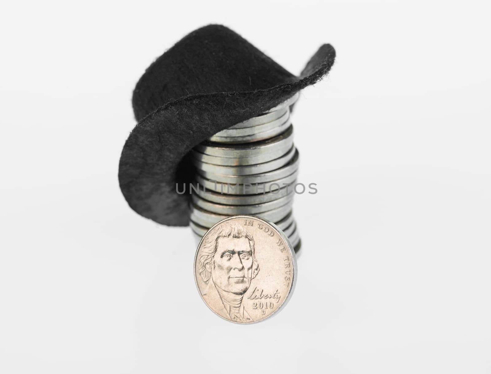 American nickel close up with black cowboy hat on a stack of nickels