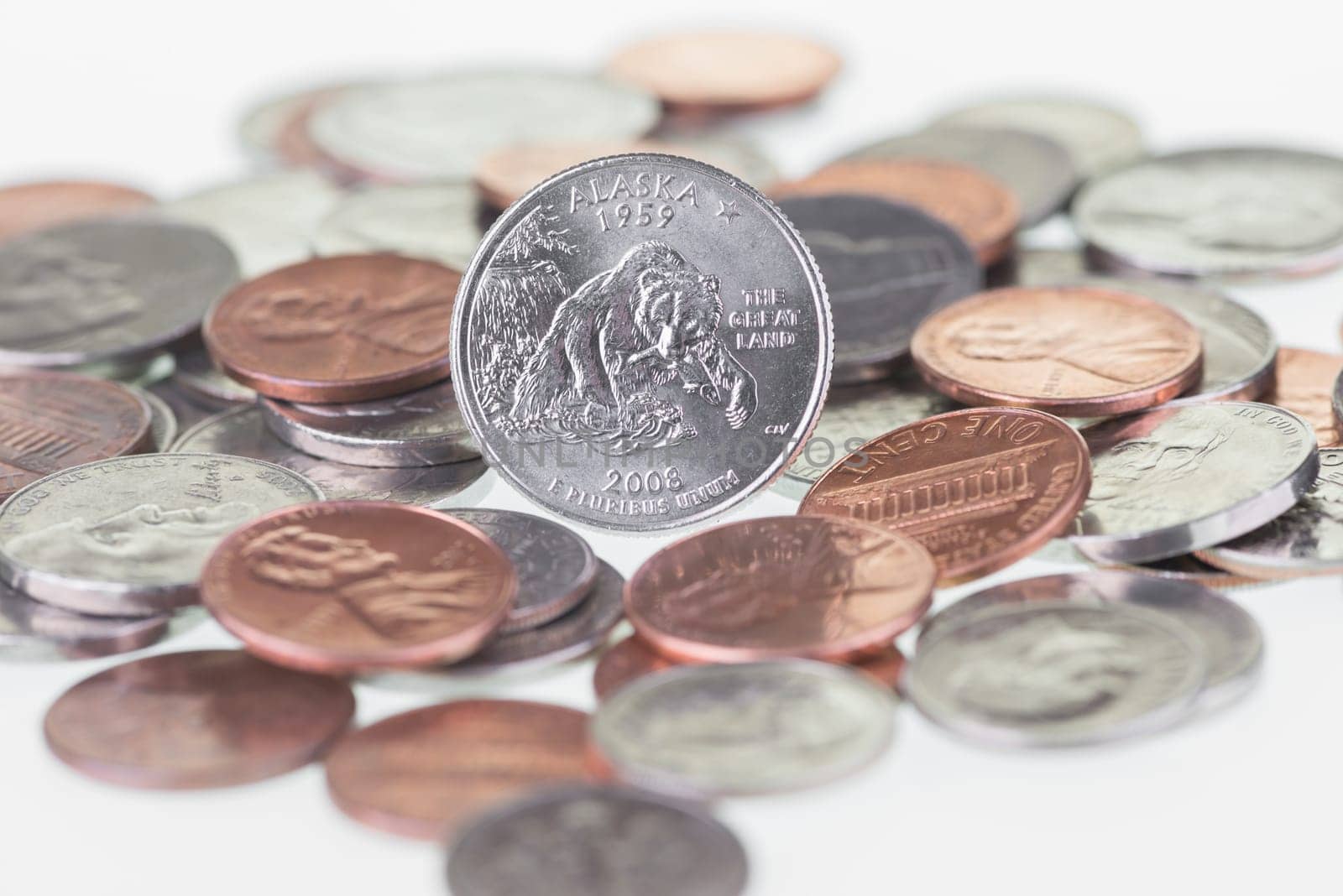 2008 Alaska State Quarter with other coins extreme close up