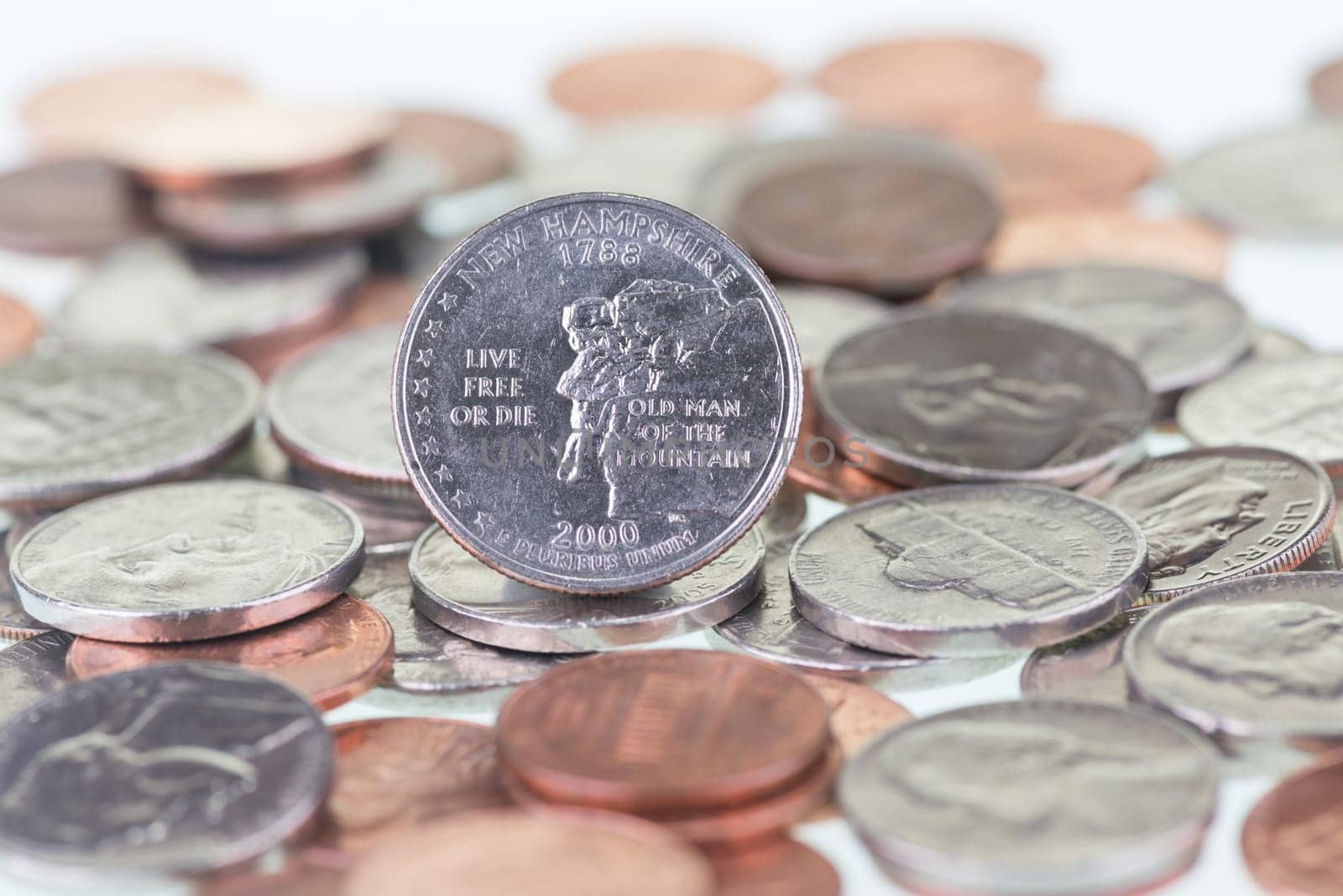 2000 New Hampshire State Quarter with other coins extreme close up