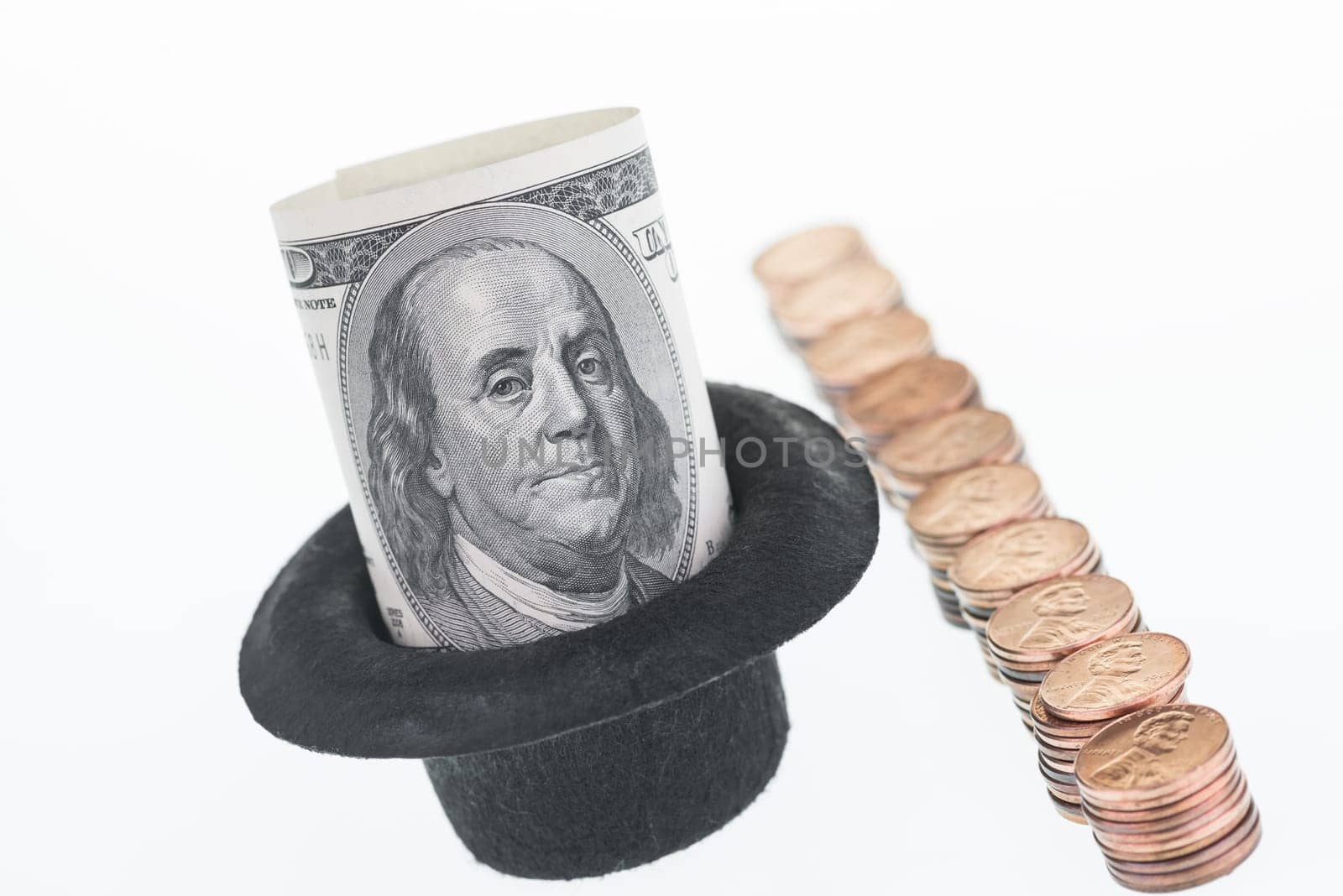 One hundred dollar note in a hat over white