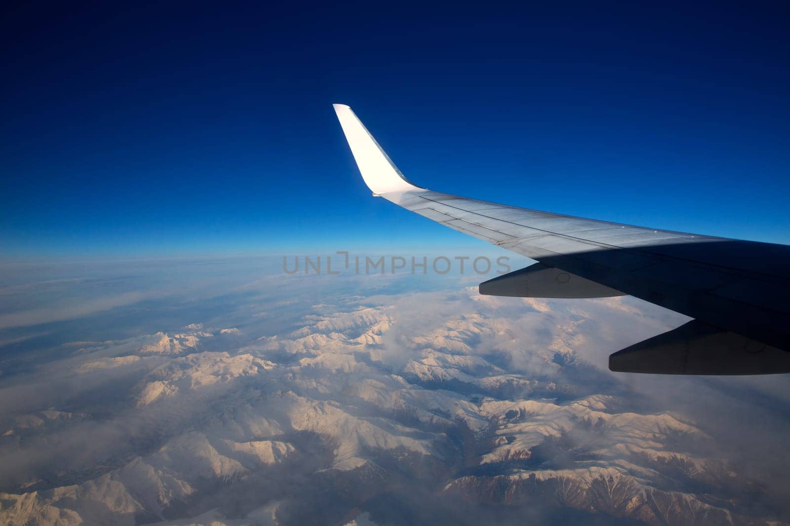 aircraft flying over snowed mountains of Pyrenees between France and Spain