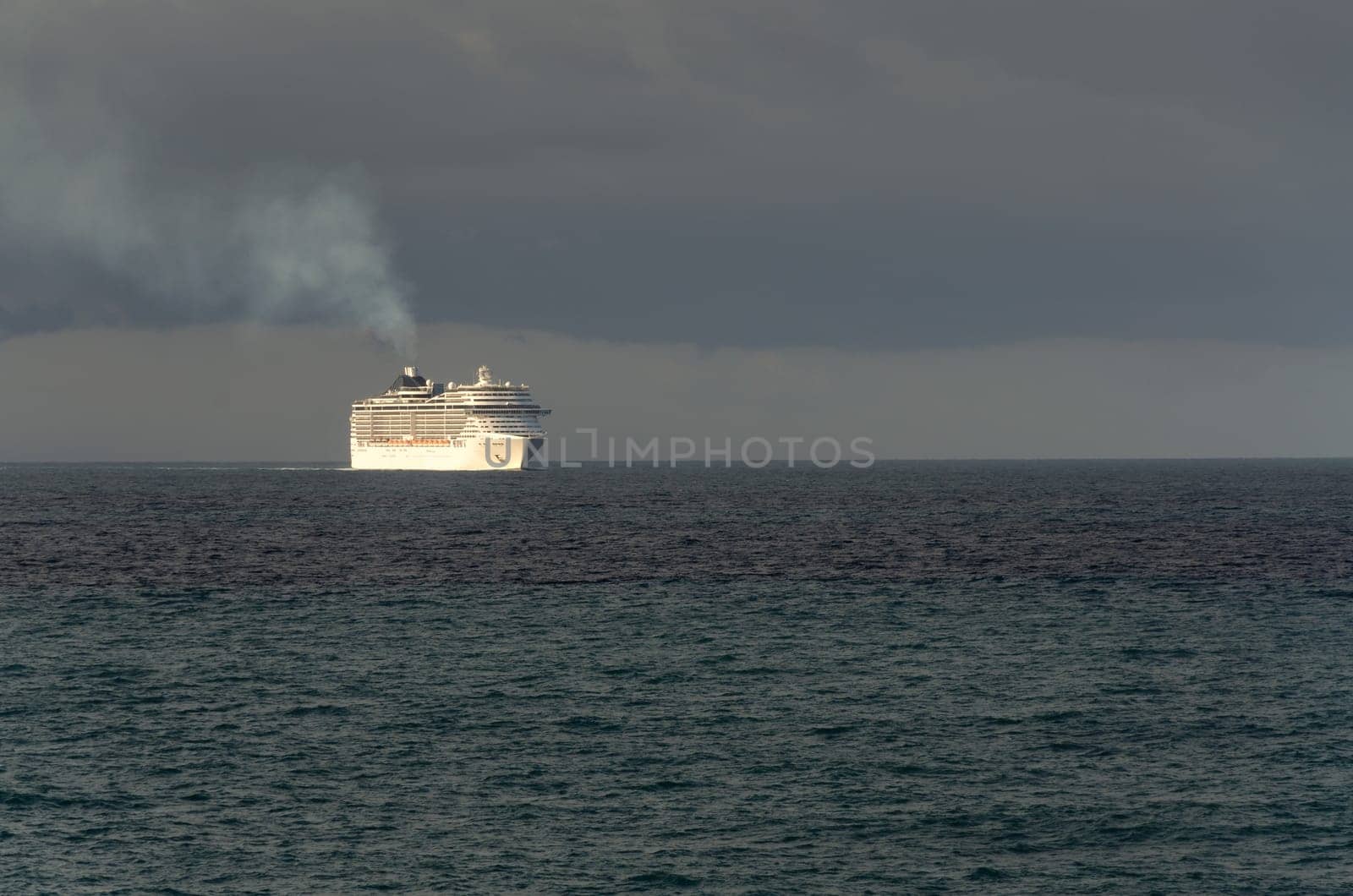 cruise ship at sunrise on the sea with black sky