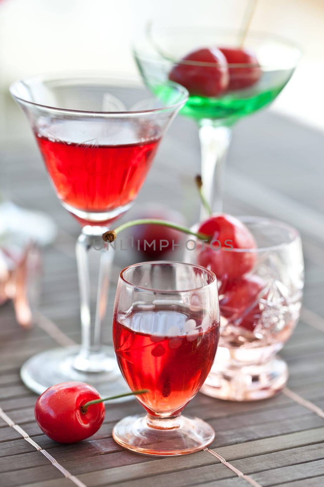 Cherry liquor in small jars with fresh cherries
