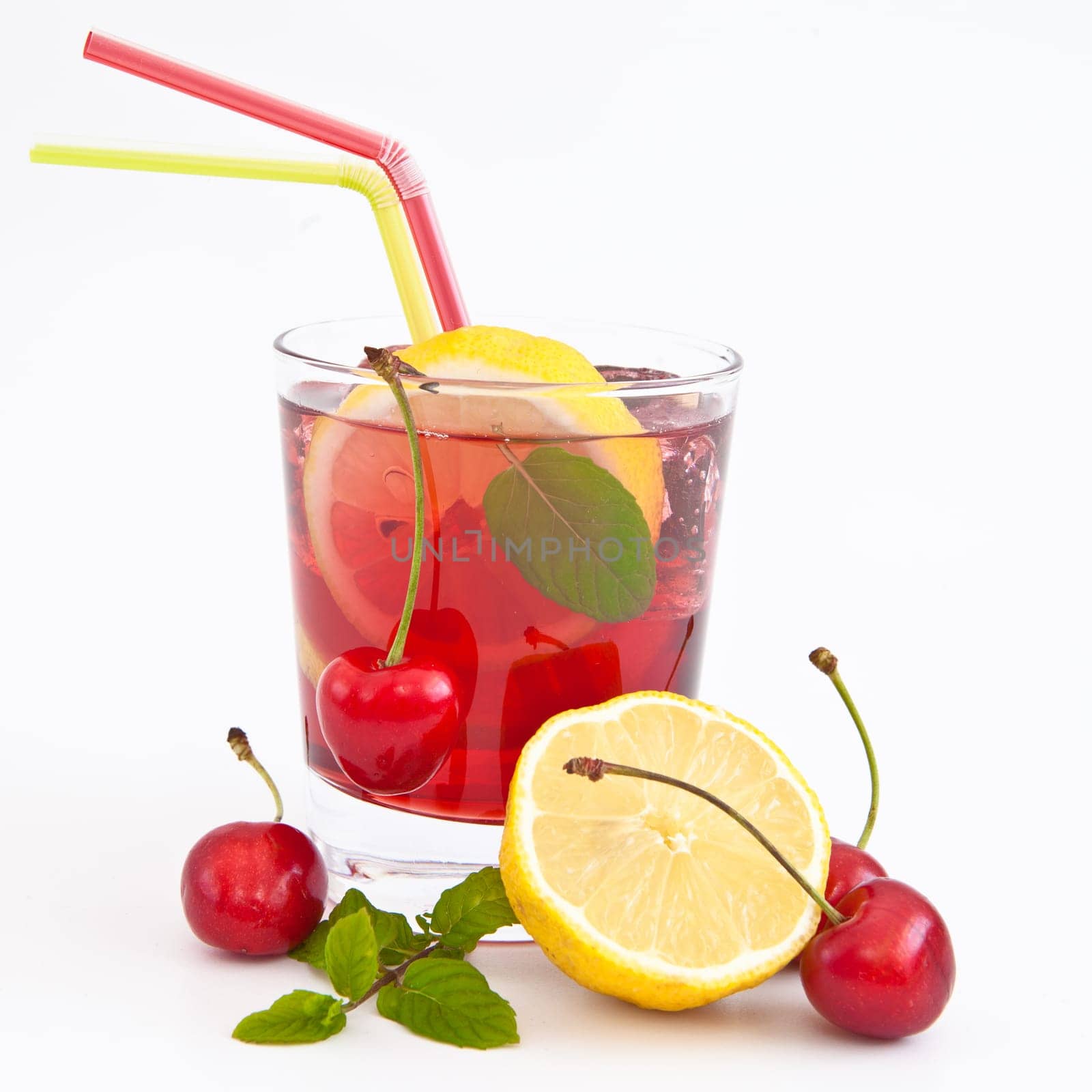Homemade lemonade with fresh lemons and cherries on white