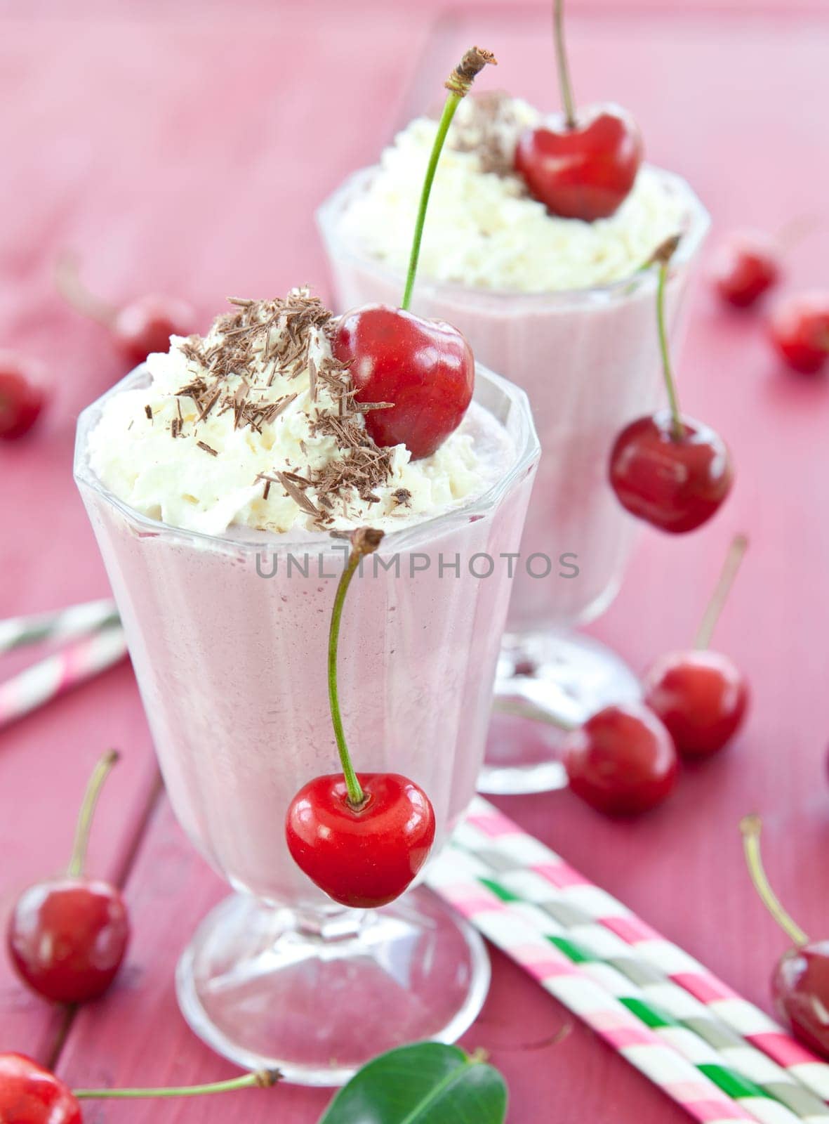Two Glser with milkshake with fresh cherries
