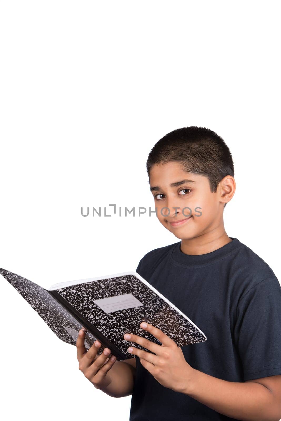 An handsome Indian kid doing his homework diligently