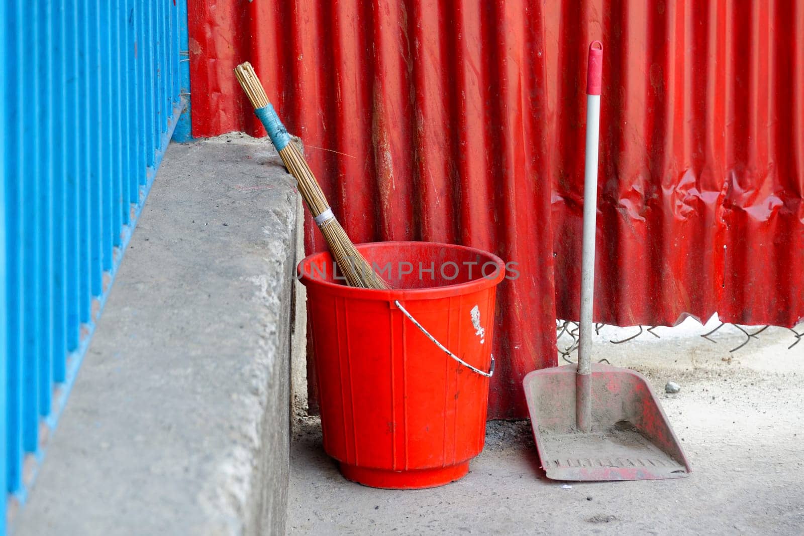 Red plastic bucket, broom and scoop