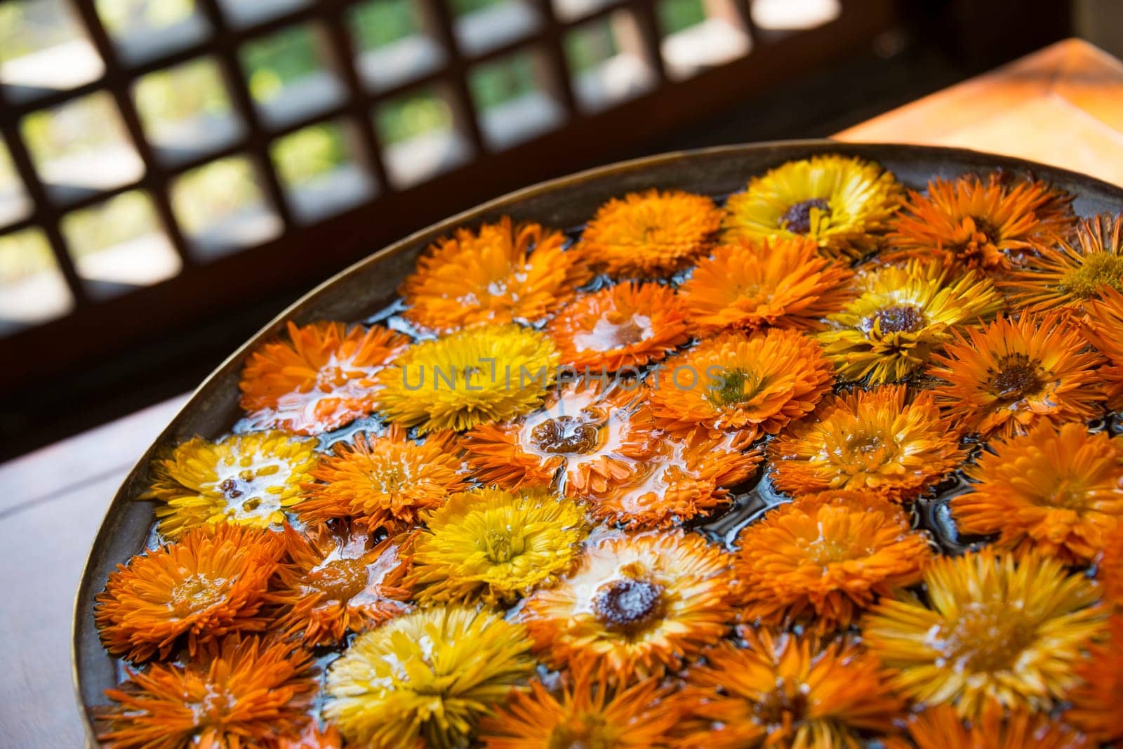 Orange and yellow flowers in water, indoor photography