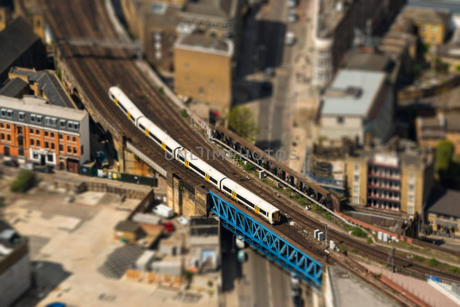 Aerial view of a train on a bridge in London, tilt-shift effect, England, UK