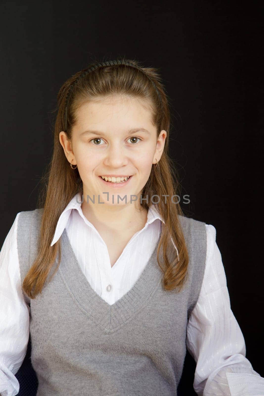 portrait of a girl with a white blouse and a gray vest
